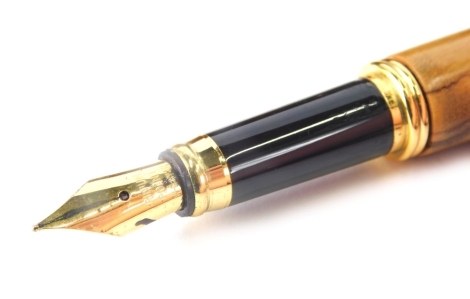 A fountain pen, with turned wooden body and lid, gilt coloured clip and nib marked Aridum Point, 14cm long. (cased)