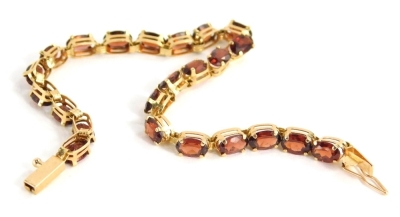 A bracelet, claw set, with oval red stones, marked 14k, 19cm long, 5.6g all in.