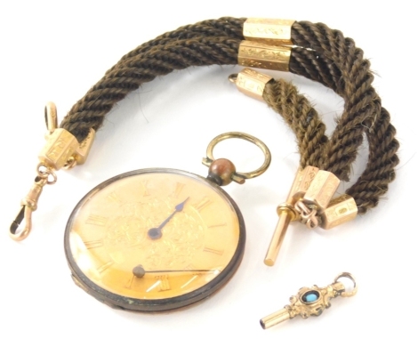 A twist watch chain, set with 9ct gold and other charms, 34cm long, a fancy watch key and early 20thC open faced pocket watch, with a lock of hair to the back with ring top and fancy face, 5cm high. (a quantity)