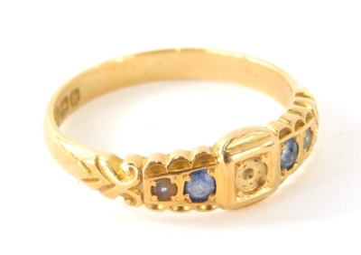 An 18ct gold dress ring, set with blue stones, size O-P. (AF)