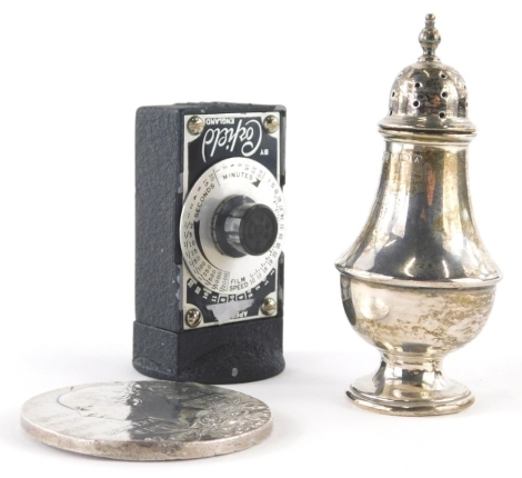 A Victorian two sided medallion, 6cm diameter, silver pepper pot, 1½oz, and a Corfield light meter. (3)