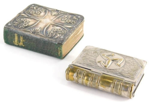 A late 19thC Isle of Man combined vesta case and stamp box, with brass mounts, marked 387573 and a silver front common prayer book, 6cm high. (2)