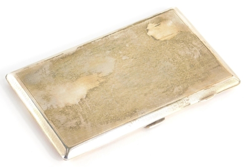 A George V silver cigarette case, partially engine turned with vacant cartouche and outer Greek key decoration with thumb mould handles and plain interior, Birmingham 1928, 14cm wide, 6oz.