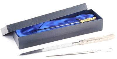 An Elizabeth II silver paper knife, in a Rowlett's case, Sheffield 1982, 20cm long, and a dagger style paper knife in Wilkinson Sword box, 1½oz silver. (3)