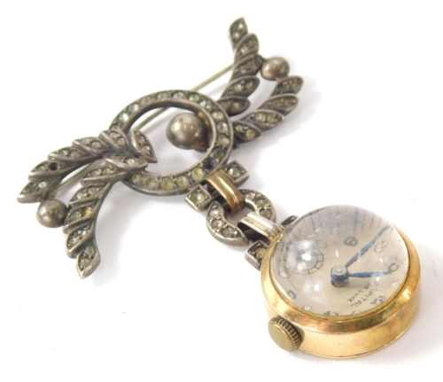 An early 20thC Capital De Luxe brooch fob watch, with an elaborate brooch with plain bin back, in a circular domed case with Arabic numerals, 6cm high.