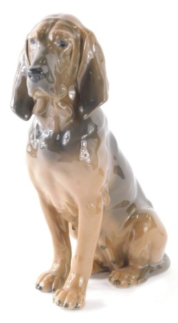 A Royal Copenhagen figure of a bloodhound seated, 1322, 21cm high.