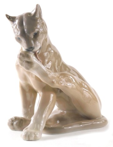 A Royal Copenhagen figure of a wild cat licking paw, 805, 18cm high.