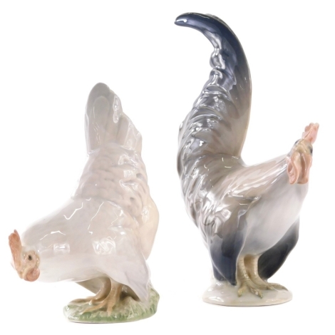 A Royal Copenhagen figure of a hen, 1024 and a cockerel, 1025, 19cm high. (2 AF)