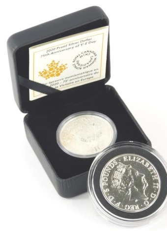 A Lion Of England 2oz £5 coin, in plastic case, outer pouch, with card and a further cased coin. (2)