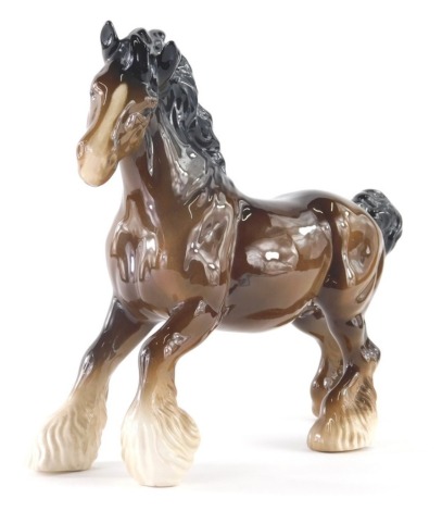 A 20thC Beswick pottery figure of a galloping shire horse, printed marks beneath, 19cm high.