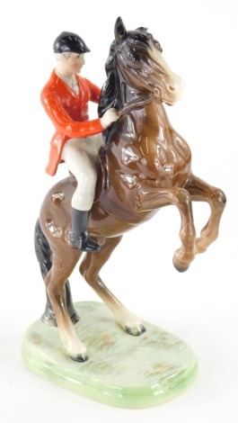 A Beswick pottery figure group, rearing huntsman, red jacket, 25cm high, printed marks beneath. (AF)