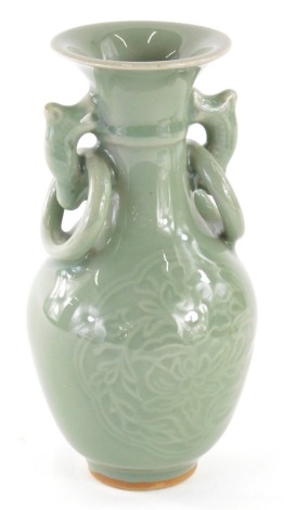 A Chinese celadon vase, of small proportions, with fixed ring handles and shouldered body, decorated with flowers, unmarked, 16cm high.