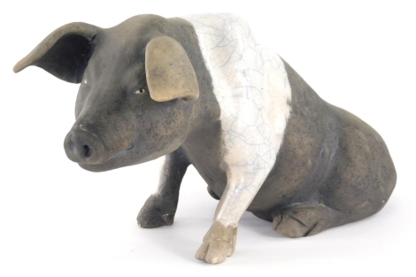 A Raku Studio pottery figure, of a saddle back pig, initialled DA SH beneath, 15cm high.