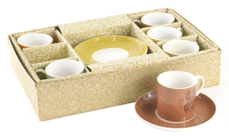 A boxed Susie Cooper Harlequin coffee service, comprising coffee cans and saucers, 14cm diameter. (settings for six)