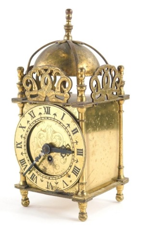 A 20thC Smiths brass lantern clock, with a domed top, 7cm diameter, Roman Numeric dial, on turned feet with turned finial, 19cm high.