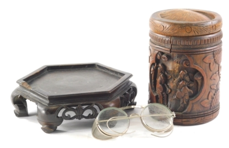 An early 20thC bamboo Chinese jar, heavily carved with figures, panels, fruits, etc., 19cm high, an Oriental wooden lamp base and a pair of protector coaching spectacles with mesh side bars and chrome plated frames. (a quantity)