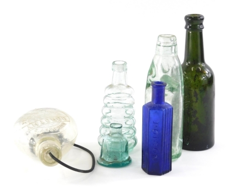 An early 20thC Our Babies glass feeding bottle, with stopper, 17cm high, doll shaped ink bottle, blue glass poison bottle, etc.