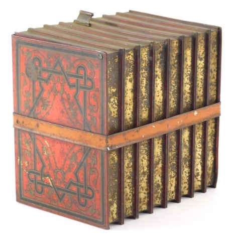 An early 20thC Huntley and Palmers biscuit tin, in the form of books in red, 16cm high.