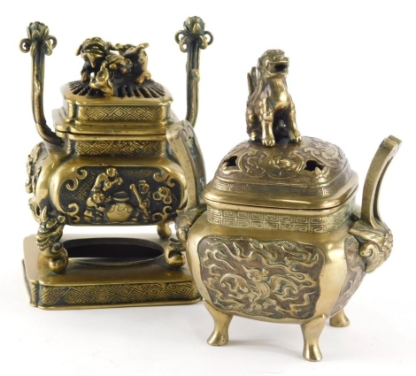 A Chinese bronze finish censer, with domed part pierced lid set with dog knob on compressed body with shaped feet, 20cm high and another similar. (2)