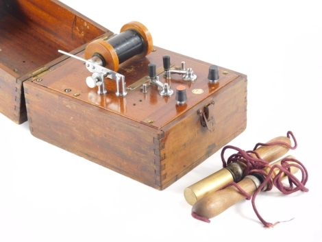 A mahogany cased electric shock machine, 1-4 settings and a Schall and son label, 17cm high, 24cm wide, 20cm deep.