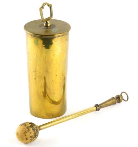 An early 20thC brass shell cased dinner gong, with cylindrical hanging central section stamped 1916, 29cm high, with separate gong.