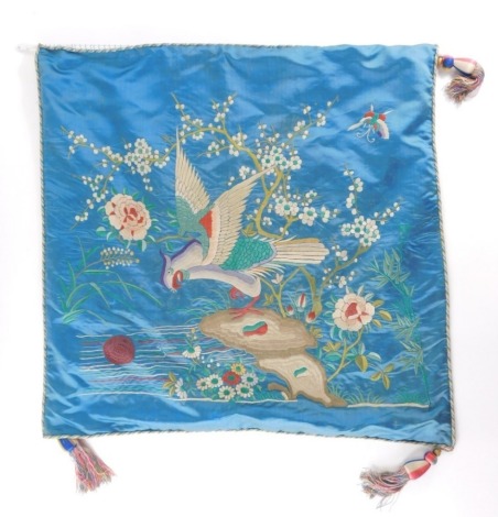 A Chinese Qing dynasty silk hanging, decorated with birds, flowers and butterflies, predominately in red, yellow and green on a blue ground with a pink backing, 54cm wide.