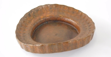 A studio copper sculpted dish, of shaped circular form with studded outline, partially marked, 25cm wide.