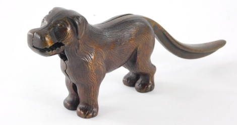 A 20thC standing bronze effect cast iron dog nutcracker, with articulated mouth and tail.