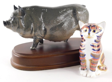 A Royal Crown Derby paperweight ornament, seated cat, silver stopper, 8cm high, (boxed) and a figure of a pot bellied pig. (2)