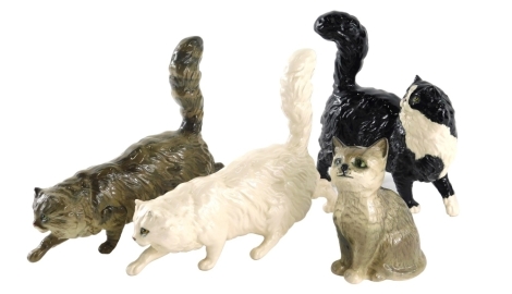 Various pottery cat ornaments, Royal Doulton creeping cat, 16cm high, another, another black and white cat, etc. (4)