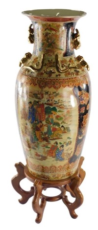 A modern Chinese floor standing vase, of shouldered circular form with gilt mouldings, decorated with panels of figures before buildings and trees with further panels of flowers, marked Made in China, on a wooden plinth base, 78cm overall.