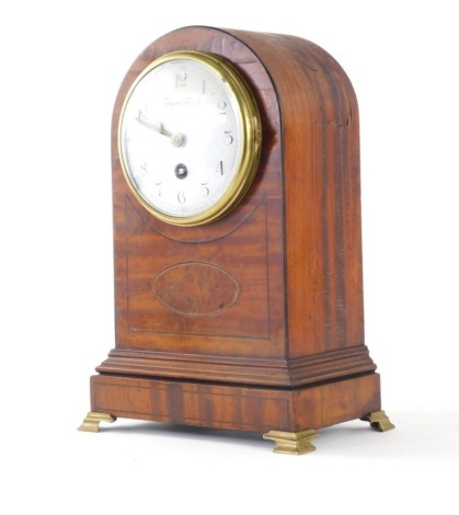 An Edwardian satinwood table clock, the domed 10cm diameter Arabic dial in an arched case, on compressed metal bracket feet, with pendulum swung movement, 31cm high.