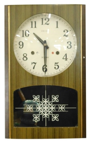 A 1960s Seiko thirty day wall clock, with partial glazed front, 20cm diameter Arabic dial and pendulum swung movement, 42m high