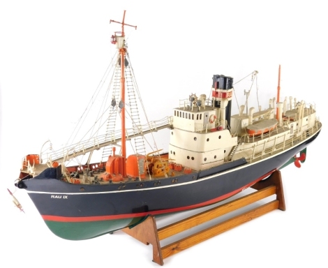 A model of a ship with realistic decking, lifeboats, rigging, masts, etc., on a wooden plinth base, 103cm wide.