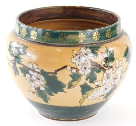 An early 20thC Royal Doulton stoneware jardiniere, of circular form decorated with flowers on a cream and green ground impressed rosette marks and other marks beneath, 20cm high.