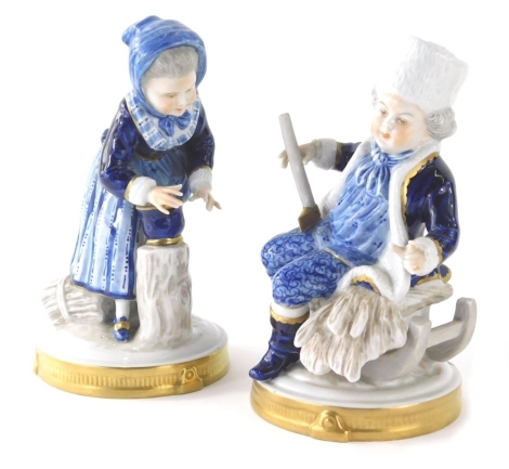 A pair of Unker Weiss Bach figures of children, each decorated in finery on gilt highlighted bases, 18cm high, etc., printed marks beneath. (2)