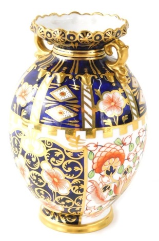 A Royal Crown Derby Imari pattern vase, of oval form with gilt highlights and circular foot, printed marks beneath, 14cm high.