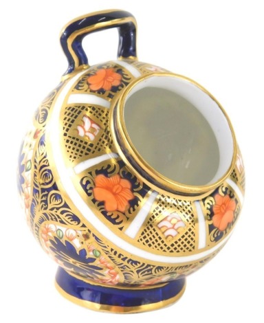 A Royal Crown Derby Imari pattern open salt pot, of cylindrical form with upper handle on circular foot, number 1128, printed marks beneath, 9cm high.