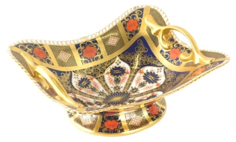 A Royal Crown Derby Imari pattern basket, of shaped oval form on oval foot, number 1128, printed marks beneath, 29cm diameter.