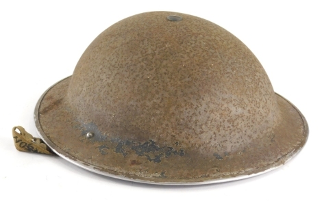 A tin war helmet, of oval form with material strap marked A Henson, with fitted interior, 27cm x 27cm.