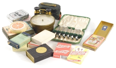 A brass hanging barometer, 12cm diameter, pair of tortoise shell finish and brass opera binoculars in a fitted case, cased set of teaspoons, playing cards, etc. (a quantity)