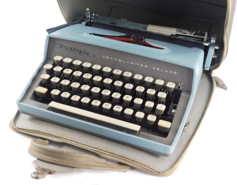 A vintage Remington Travel-riter Deluxe typewriter, in blue colourway, in fitted case, 32cm wide.