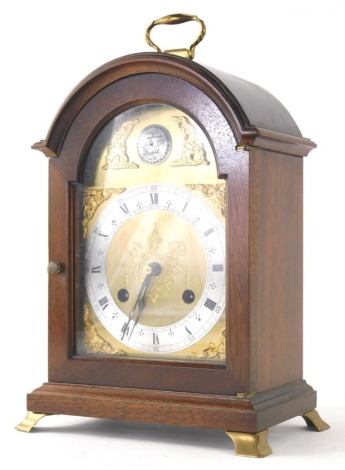 A modern Tempus Fugit mantel clock, in mahogany case with brass fittings, and arched dial with raised spandrels, the 11cm diameter Roman numeric and Arabic dial, fronting an eight day key wind movement, striking on a bell, with two associated keys, 31cm h