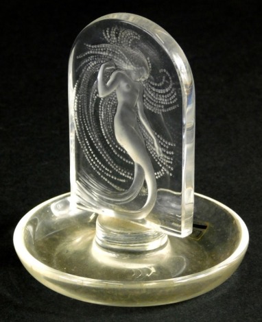 A modern Lalique pin dish, set with mermaid on circular base, etched mark beneath, 11cm high.