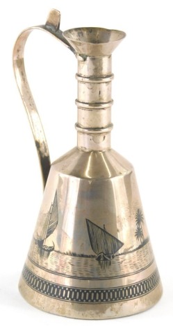 A continental niello decorated white metal flagon, of bell shaped form, with plain handle, decorated with boats, with a lower banding, unmarked, possibly Egyptian, 13cm high.