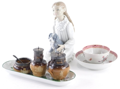 A Nao figure of a girl seated holding puppy, printed marks beneath, 20cm high, an early 19thC Newhall tea bowl and saucer, oval dish and Royal Doulton cruet set with silver mount. (a quantity)