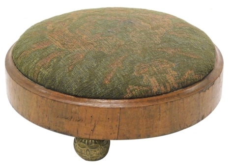 A Victorian mahogany footstool, with a later padded top and gilt metal spherical feet, 29cm diameter.