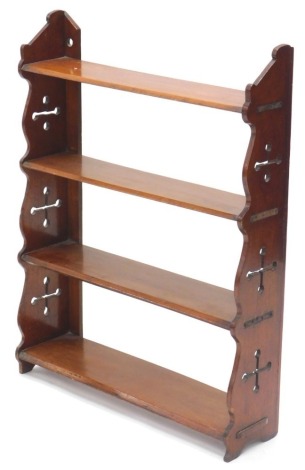 A Victorian mahogany three tier wall shelf, with shaped and Gothic pierced sides, 56cm wide, 74cm high.