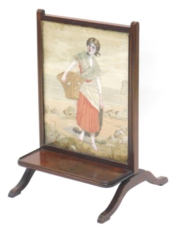 A late 19thC mahogany fire screen, the inset with a banner of woven silk, depicting a fishing lady with basket and net, etc., beside a coastal landscape, above a galleried shelf on splayed legs, 63cm high, 40cm wide.