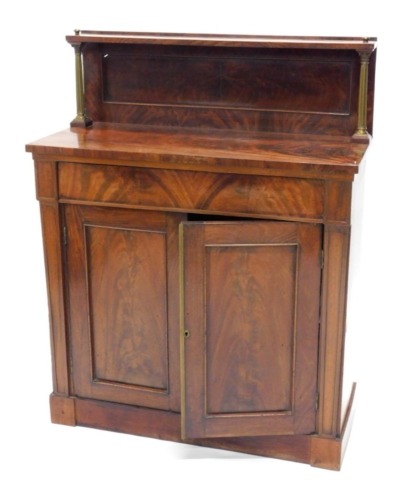 An early Victorian mahogany chiffonier, the raised back supported by brass columns, the base with a frieze drawer above two panelled doors on a plinth, 115cm high, 90cm wide, 40cm deep.